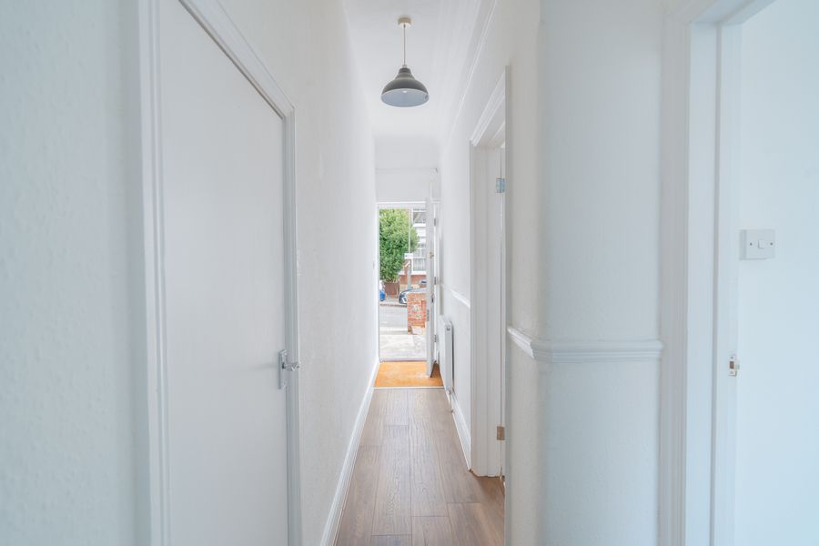 Long hallway with a wooden floor