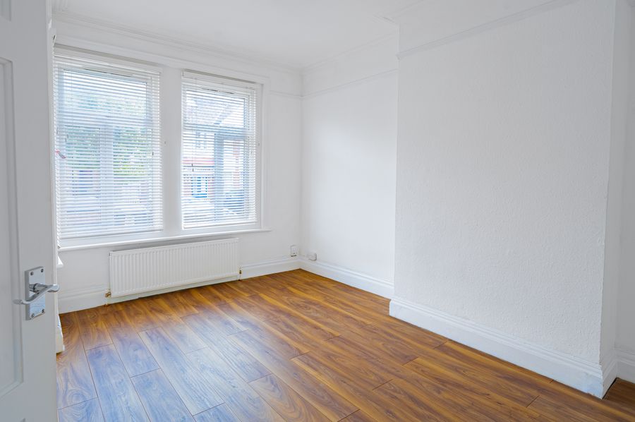 Living room with bay windows and a wooden floor