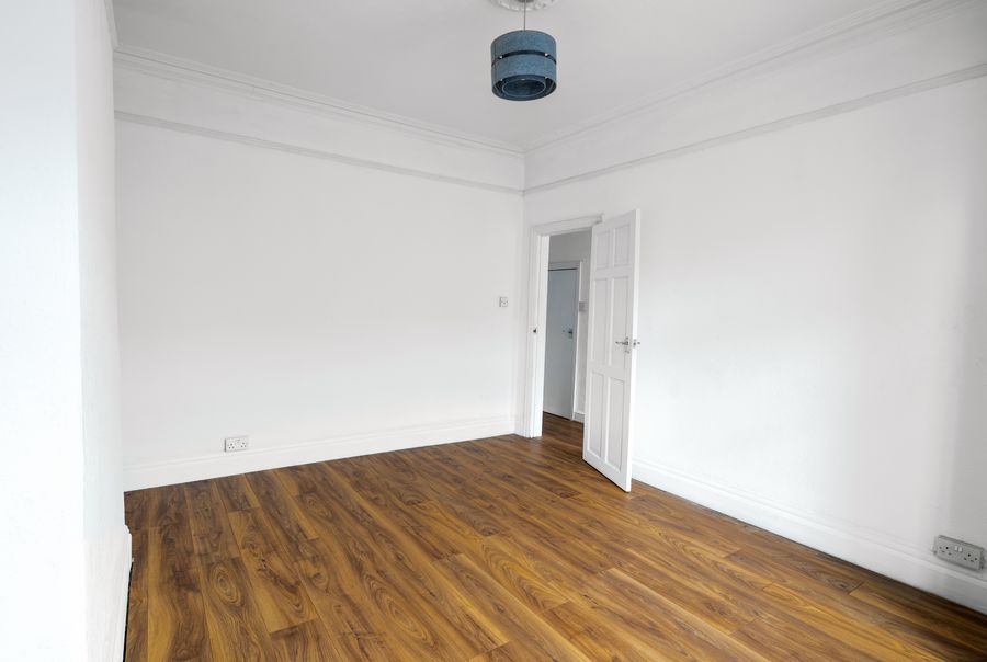 Living room seen from the window, with the door to the hallway